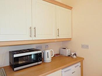 Kitchen with microwave, kettle and toaster